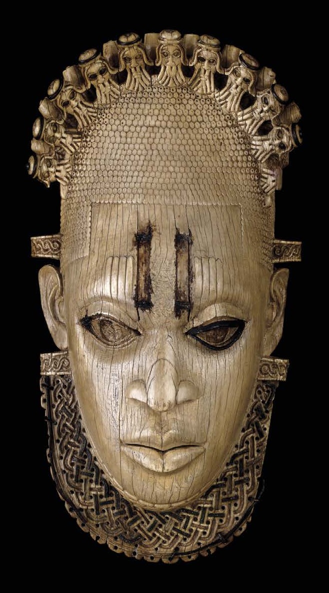 The British Museum pendant against black: the same composed face, crowned by Portuguese heads with no mudfish, above a collar of woven interlace.