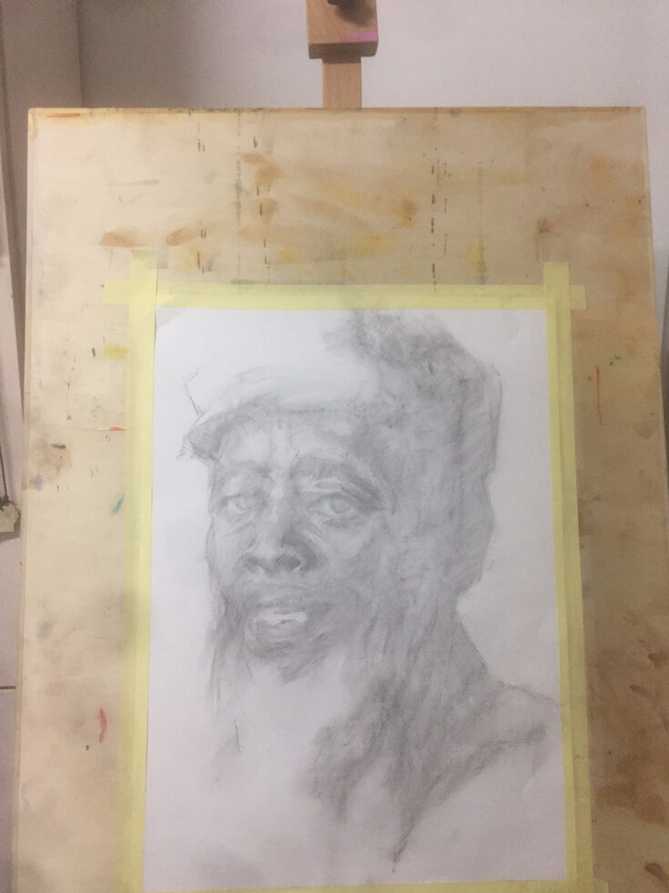 Process, stage one: a faint graphite outline of the face taped to a board.