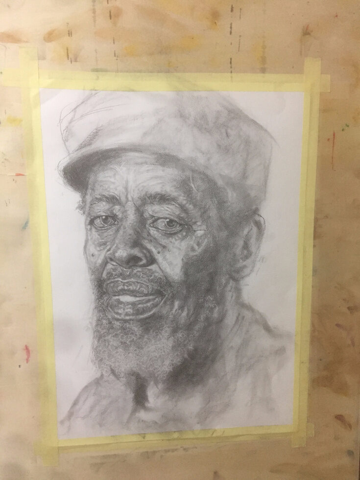 Process, stage three: the eyes, beard and creases of the face built up in charcoal.