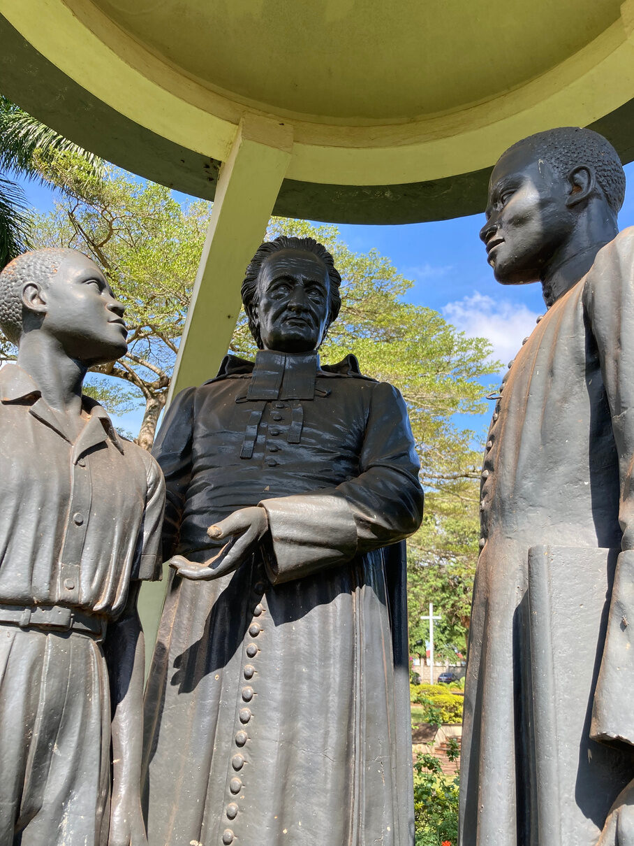 Close view of the priest figure between the boy and the young Brother.