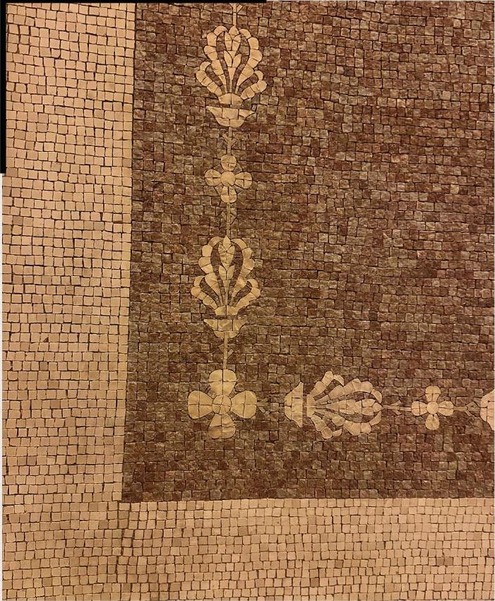 Detail of a brown and gold mosaic border with palmette motifs.