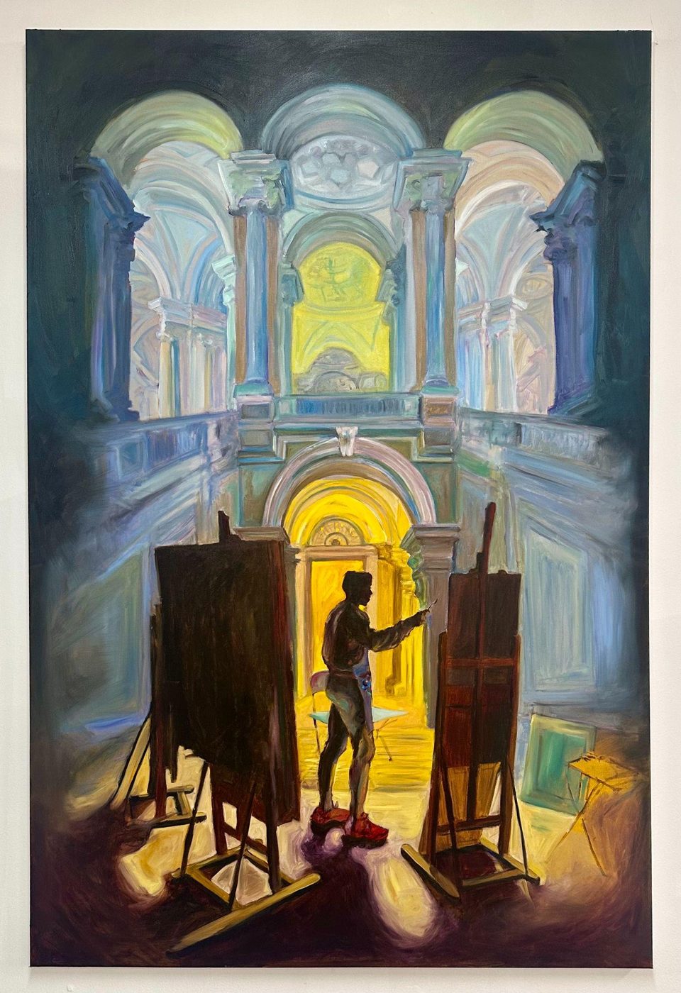 Studio Akkim 514: a painter at work among easels in a vaulted, light-filled interior, the canvas divided between painted and drawn passages.